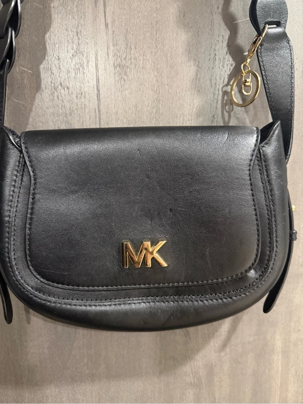 ⁠MICHAEL KORS Jolene black leather saddle bag with interlocking woven strap